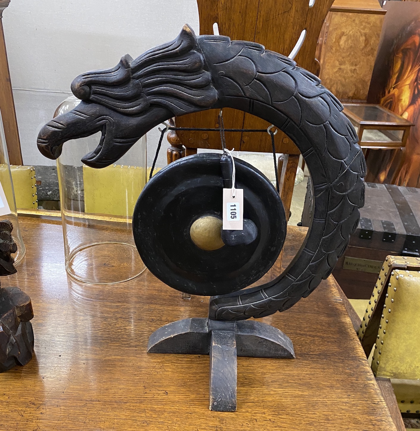 A Chinese carved dinner gong and striker, height 66cm